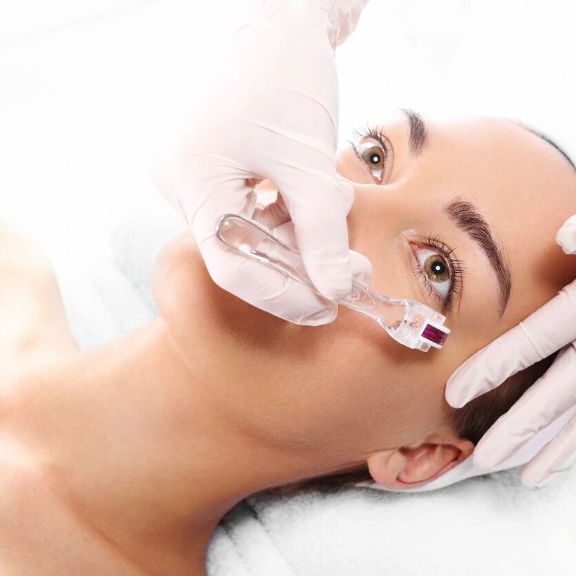 A woman getting her face waxed at the spa